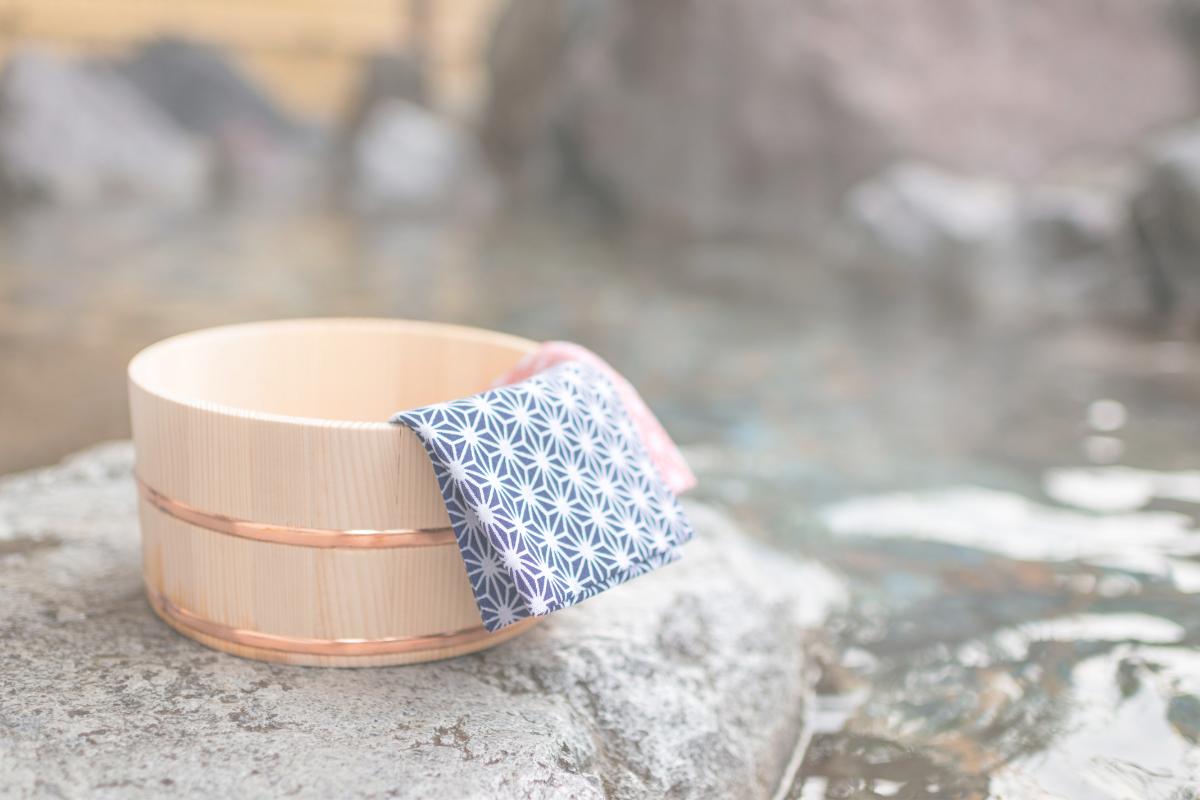 A bathing bucket placed beside a hot spring bath in Japan