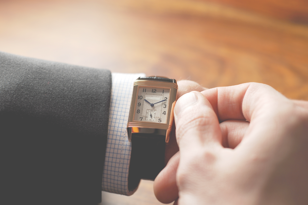 A person looking at their wristwatch to check the time
