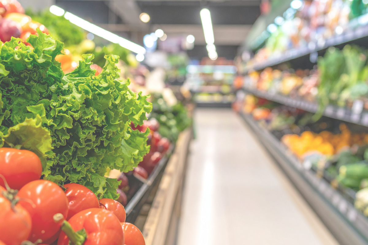 Fresh vegetables displayed in the produce section of a supermarket